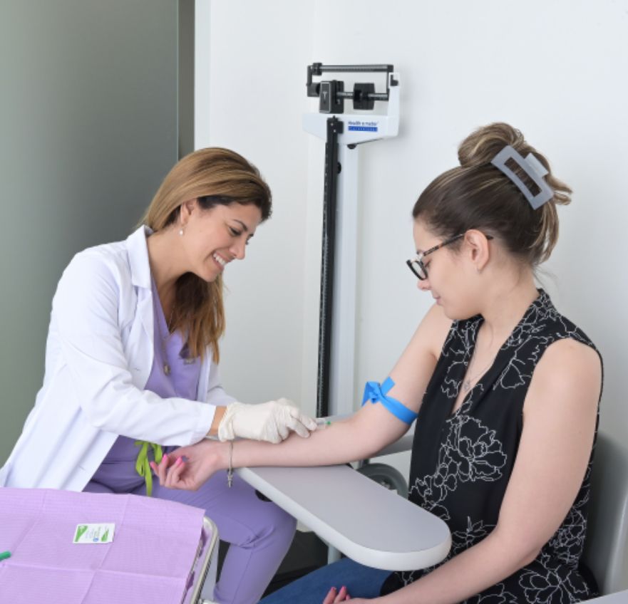 A HayaCare provider drawing blood from a patient